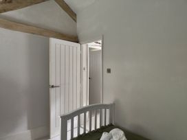 A bedroom with a bed and an open door at Islwyn in Llanuwchllyn near Bala