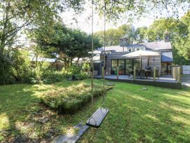 A garden with a swing and decking area at Islwyn in Llanuwchllyn near Bala