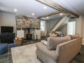 A living room with a fireplace and television at Islwyn, Llanuwchllyn near Bala