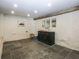 A room with a storage cabinet and mirrors at Islwyn Llanuwchllyn near Bala