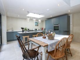 A kitchen with a table and chairs at Islwyn near Bala
