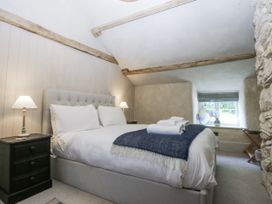 A bedroom with a bed and nightstand at Islwyn Llanuwchllyn near Bala
