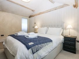 A bedroom with a double bed and bedside table at Islwyn near Bala