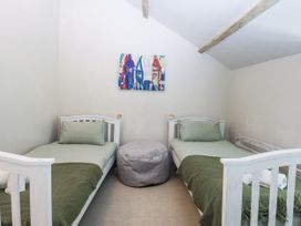 A bedroom with twin beds and a bean bag at Islwyn near Llanuwchllyn Bala