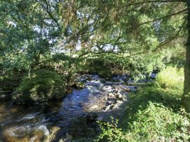 A river flowing beside rocks and trees at Islwyn in Llanuwchllyn near Bala