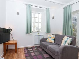 A living room with a television and a sofa at Nest Cottage in St Tudy