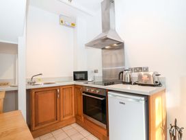 A kitchen with various appliances at Nest Cottage in St Tudy