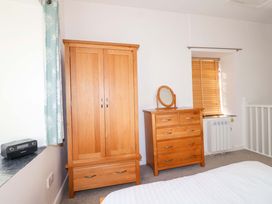 A bedroom with wardrobe and dresser at Nest Cottage in St Tudy