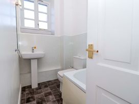 A bathroom with a sink, toilet, and bathtub at Nest Cottage in St Tudy