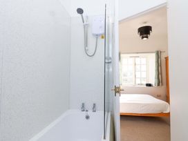 A bathroom with a bathtub and shower at Nest Cottage in St Tudy