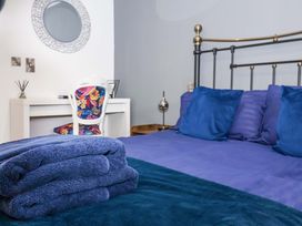 A bedroom with a bed and a desk at Chalet 1 in Sherburn