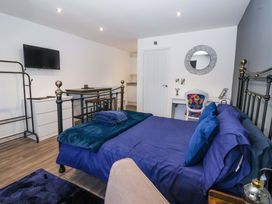 A bedroom with a bed and a television at Chalet 1 in Sherburn