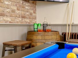 A snug with a barrel, drinks, stool, and a pool table at Y Graiglwyd Bull Bay near Amlwch