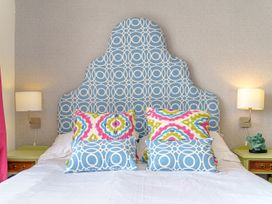 A bedroom with a bed and decorative pillows at Y Graiglwyd near Bull Bay Amlwch