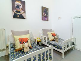 A bedroom with two beds and toys at Y Graiglwyd in Bull Bay near Amlwch