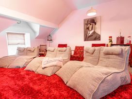 A living room with bean bags and a rug at Y Graiglwyd Bull Bay near Amlwch