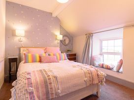 A bedroom with a bed and a window seat at Y Graiglwyd in Bull Bay near Amlwch