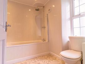 A bathroom with a bathtub and shower at Y Graiglwyd Bull Bay near Amlwch