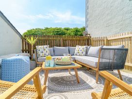 An outdoor seating area with a sofa and table at Y Graiglwyd Bull Bay near Amlwch