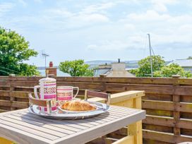 A table with a tray of coffee and a croissant at Y Graiglwyd Bull Bay near Amlwch