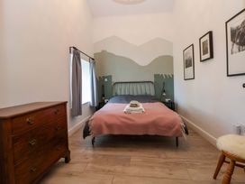 A bedroom with a bed and dresser at Cwtch in Mold