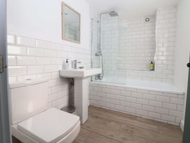 A bathroom with a sink, toilet, and shower at Cwtch Mold