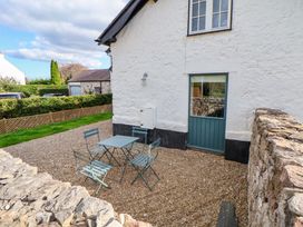 An outdoor seating area with a table and chairs at Cwtch in Mold