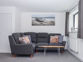 A living room with a sofa and coffee table at Driftwood in Torquay