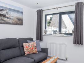 A living room with a sofa and window at Driftwood in Torquay