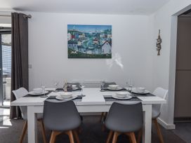 A dining room with a table set for dinner at Driftwood in Torquay