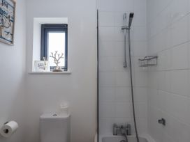 A bathroom with a shower and toilet at Driftwood in Torquay