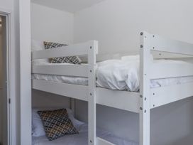A bunk bed with pillows and blankets at Driftwood in Torquay
