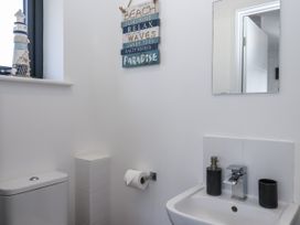 A bathroom with a toilet and sink at Driftwood in Torquay