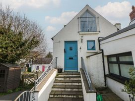 A house with a blue door and steps at Awen Ingli Newport, Pembrokeshire