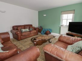 A living room with sofas and a coffee table at Awen Ingli in Newport, Pembrokeshire