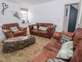 A living room with leather sofas and a wooden coffee table at Awen Ingli Newport, Pembrokeshire