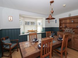 A dining room with a wooden table and chairs at Awen Ingli, Newport, Pembrokeshire