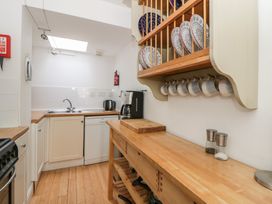 A kitchen with cabinets and utensils at Awen Ingli Newport, Pembrokeshire