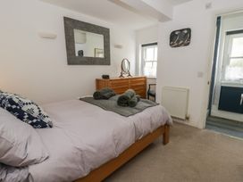 A bedroom with a bed and dresser at Awen Ingli Newport, Pembrokeshire