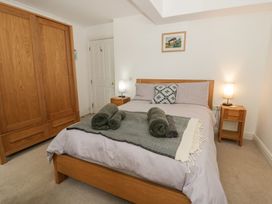 A bedroom with a bed and wardrobe at Awen Ingli, Newport, Pembrokeshire