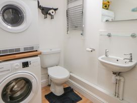 A laundry room with washing machine and dryer at Awen Ingli in Newport, Pembrokeshire