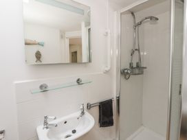A bathroom with a shower and wash basin at Awen Ingli, Newport, Pembrokeshire