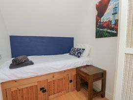 A bedroom with a bed and bedside table at Awen Ingli in Newport, Pembrokeshire