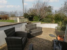 A garden with seating and plants at Awen Ingli in Newport, Pembrokeshire