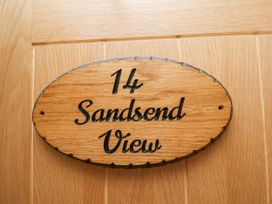 A name plate showing 14 Sandsend View in the entryway of the property