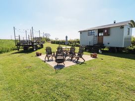 An outdoor area with chairs and a firepit at Sweet Caroline Shepherd’s Hut Low Marnham near Sutton-On-Trent
