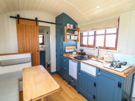 A kitchen with a sink and stove at Sweet Caroline Shepherd’s Hut Low Marnham near Sutton-On-Trent