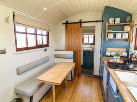 A kitchen with seating space and cabinets at Sweet Caroline Shepherd’s Hut Low Marnham near Sutton-On-Trent
