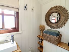 A bathroom with a sink and mirror at Sweet Caroline Shepherd’s Hut in Low Marnham near Sutton-On-Trent