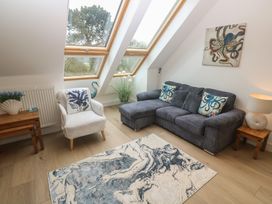 A living room with a sofa and armchair at Upper Deck in Truro
